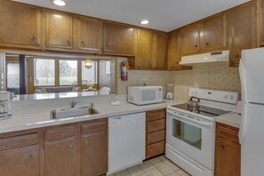Cook delicious meals in the fully equipped kitchen, designed for convenience with modern appliances and ample counter space.