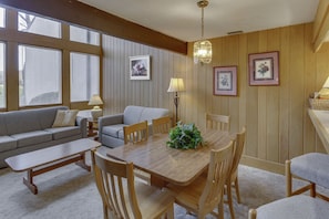 The comfortable living and dining area is perfect for family gatherings, featuring a smart TV, WiFi, and a fireplace to keep warm and cozy.