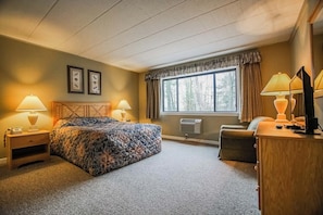 This cozy bedroom features a queen bed and ample natural light, ideal for relaxation in your two-bedroom condo with modern amenities.
