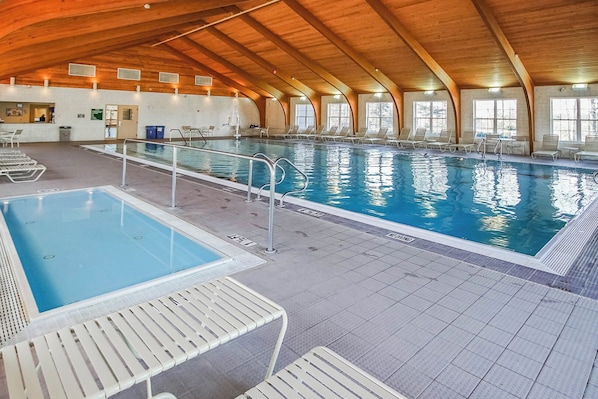 Immerse yourself in tranquility at the indoor pool area, complete with a hot tub and ample seating for relaxing after a day exploring nearby golf courses.