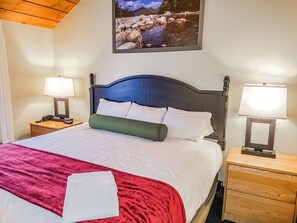 Experience comfort in the cozy bedroom featuring a plush bed and elegant decor, perfect for restful nights after exploring the White Mountains.