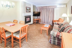 Enjoy a warm and inviting living space with a fireplace lounge and dining area, perfect for family gatherings after a day of exploring the nearby White Mountains.