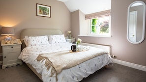 The view from bedroom one is framed in wisteria