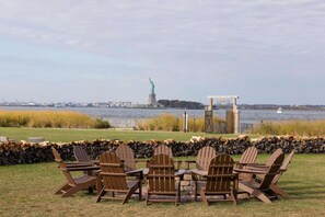 Fire pit with chairs and a view of the Statue of Liberty