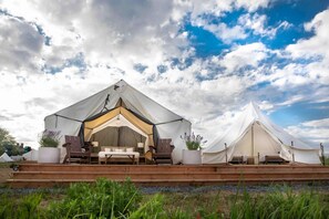 Journey family tents with flower pots and wood steps outside