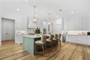Elegant kitchen with high end appliances and bar top seating