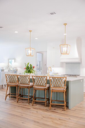 Chef's kitchen with bar seating for four.