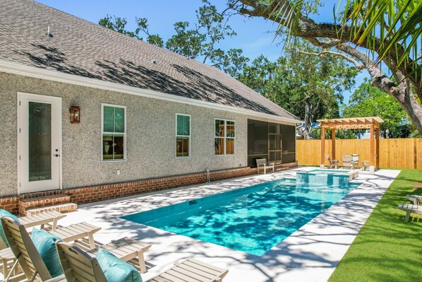 Enjoy the backyard with sunbathing and a refreshing dip in the pool and spa