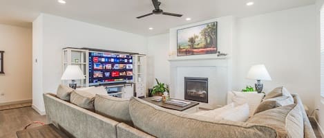 Unwind in this cozy living room with natural light and modern touches.