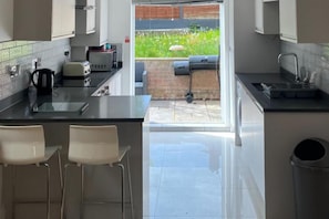 Open plan kitchen leading into well maintained garden with BBQ facilities and garden furniture.