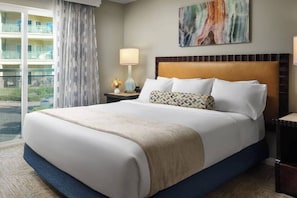 The bedroom features a king bed, TV, dresser, and ensuite bathroom.
