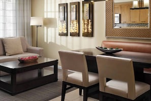 Separate living and dining areas. The living area features a sleeper sofa for two.