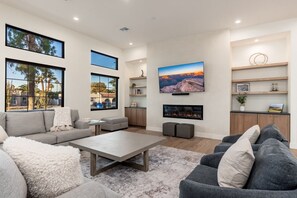 Relax by the living area with TV and indoor fireplace