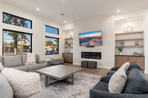 Relax by the living area with TV and indoor fireplace