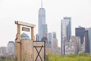 Wooden gate with skyline backdrop and 'Collective Retreats' sign