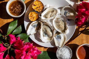 Fresh oysters with grilled lemon and dipping sauces