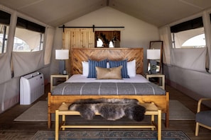 Summit King Plus interior with bed, cozy blankets, and soft lighting