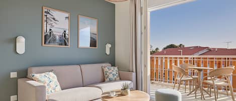 Enjoy seamless indoor-outdoor living with expansive windows in the living area that open up to your balcony, allowing plenty of natural light to brighten your stay.