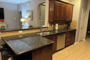 Kitchen has plenty of cabinets with all the kitchen supplies you need and stainless appliances.