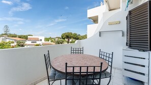 A private balcony is perfect for enjoying a relaxed outdoor meal or savoring a morning coffee. Enjoy peaceful neighborhood views under a clear blue sky, blending tranquility in a charming setting. #Algarve #summer #vacations #apartment