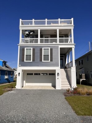 Stunning three-story beach house just 1.5 blocks from the shore, offering modern elegance and coastal charm.