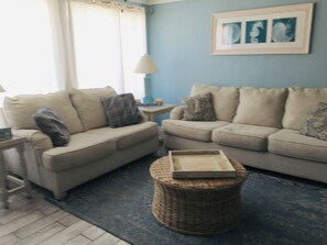 sit in living room gaze out the window at ocean