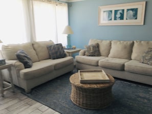 sit in living room gaze out the window at ocean