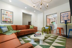 Color outside the lines—this bold, funky living room is ready to wow your feed and your stay!"
