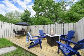 Whether it's s’mores by the fire or dinner under the stars, this outdoor setup with a fire pit and patio seating is made for making memories