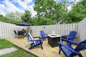 Whether it's s’mores by the fire or dinner under the stars, this outdoor setup with a fire pit and patio seating is made for making memories