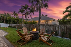 Fire Pit Paradise: Gather 'round for enchanting evenings under a stunning sunset sky!