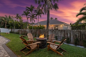 Fire Pit Paradise: Gather 'round for enchanting evenings under a stunning sunset sky!