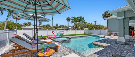 Outdoor Oasis: Dive into relaxation by the shimmering pool under the sunny Florida sky!