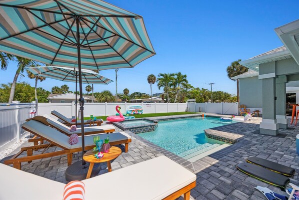 Outdoor Oasis: Dive into relaxation by the shimmering pool under the sunny Florida sky!