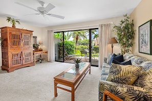 Cozy living room with a comfortable sofa, coffee table, and access to a private outdoor patio.