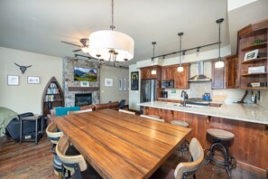 The rustic-inspired dining set seats 6 guests, with space for an additional 3 guests at the kitchen bar.
