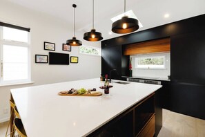 Art TV in the kitchen, with pantry / fridge concealed behind cabinetry.