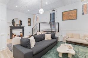 Open-Concept Living Area featuring designer furnishings, and a Smart TV.