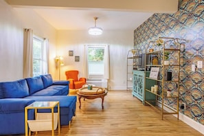 Living room also has a ceiling fan inside the upper light fixture (the fan blades come out when turned on, called a "fandelier").
