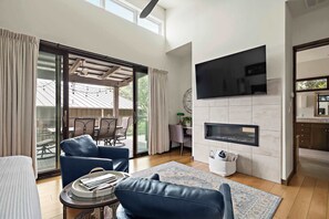 Open-concept design blends the bedroom and living area for a warm, spacious feel.