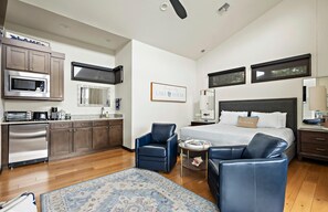 The inviting main living area features a king-size bed, large TV, and a cozy fireplace ideal for unwinding after a day at the lake.
