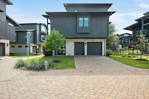Escape to this modern Lake Travis retreat featuring an open layout, gourmet kitchen, cozy loft, and game room with a pool table.