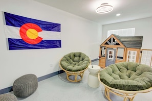 The garage has been turned into a fun game room with ping pong, a TV, a kids playhouse, connect four, plastic axe throwing and more!