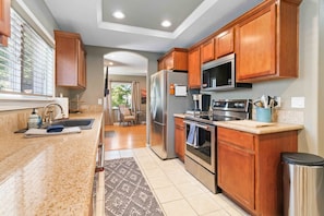 Stainless steel appliances and granite countertops in the fully-equipped kitchen