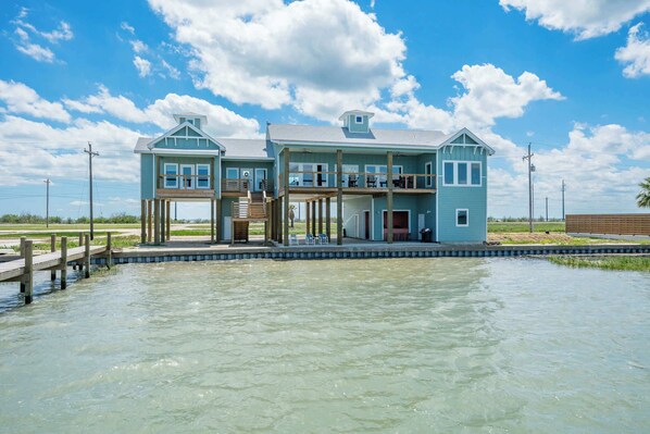 Your coastal escape awaits – one-level living elevated on 12' piers for panoramic waterfront views.