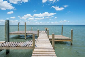 A coastal masterpiece with private dock access and endless water views!