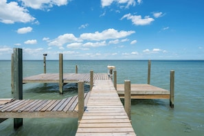A coastal masterpiece with private dock access and endless water views!
