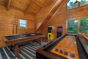 Level up your fun in the loft game room—complete with arcade classics, a pool table, and shuffleboard!
