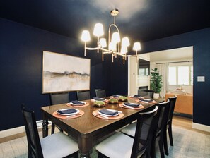 This large, moody dining room sets the tone for memorable meals and meaningful conversation. Designed with a dramatic color palette and sophisticated ambiance, it features a striking 8-top dining table—perfect for hosting family dinners, group celebrations, or cozy holiday feasts.
Modern lighting fixtures and carefully selected contemporary artwork add style and edge, while th...