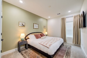 Bedroom with queen bed and tv